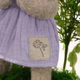 Close up of stuffed bunny in a purple dress