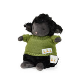 Plush toy lamb with a green sweater on a white background